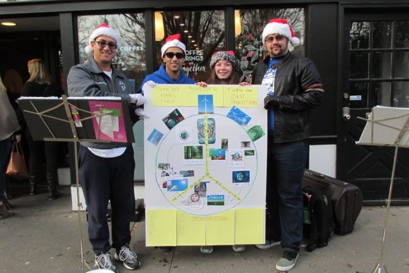 Group of four people with sign