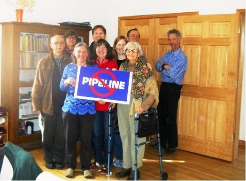 Group standing with "No Pipeline" Sign
