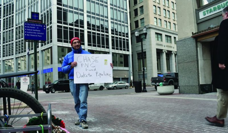 Man holding sign outside of Chase bank