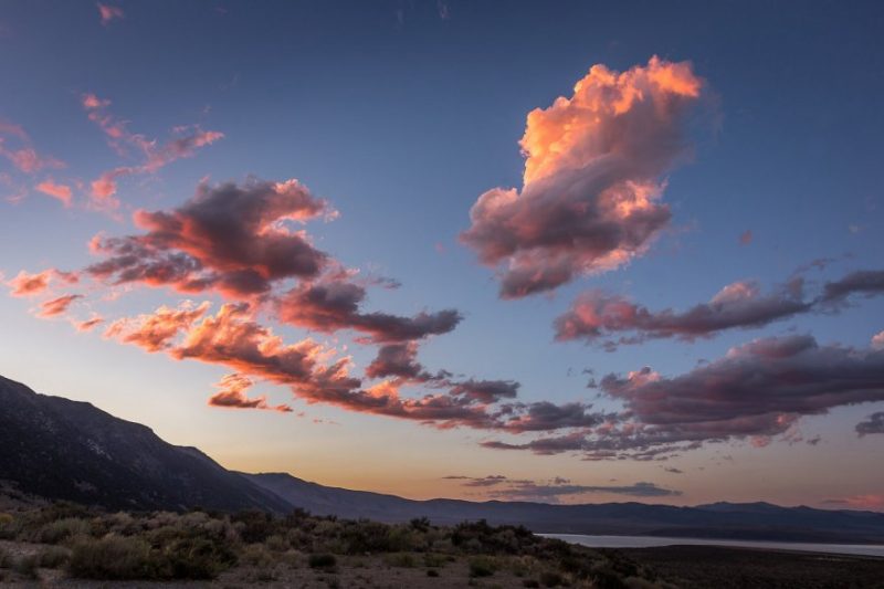 Pink sunset clouds above mountains