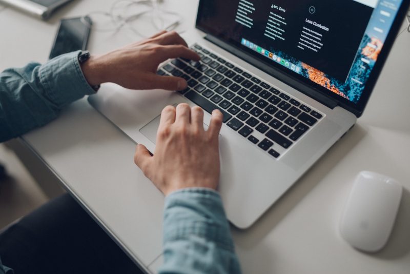 Hands working at computer laptop