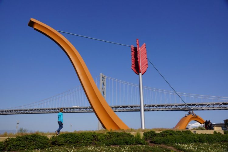 Yellow sculpture in front of blue sky