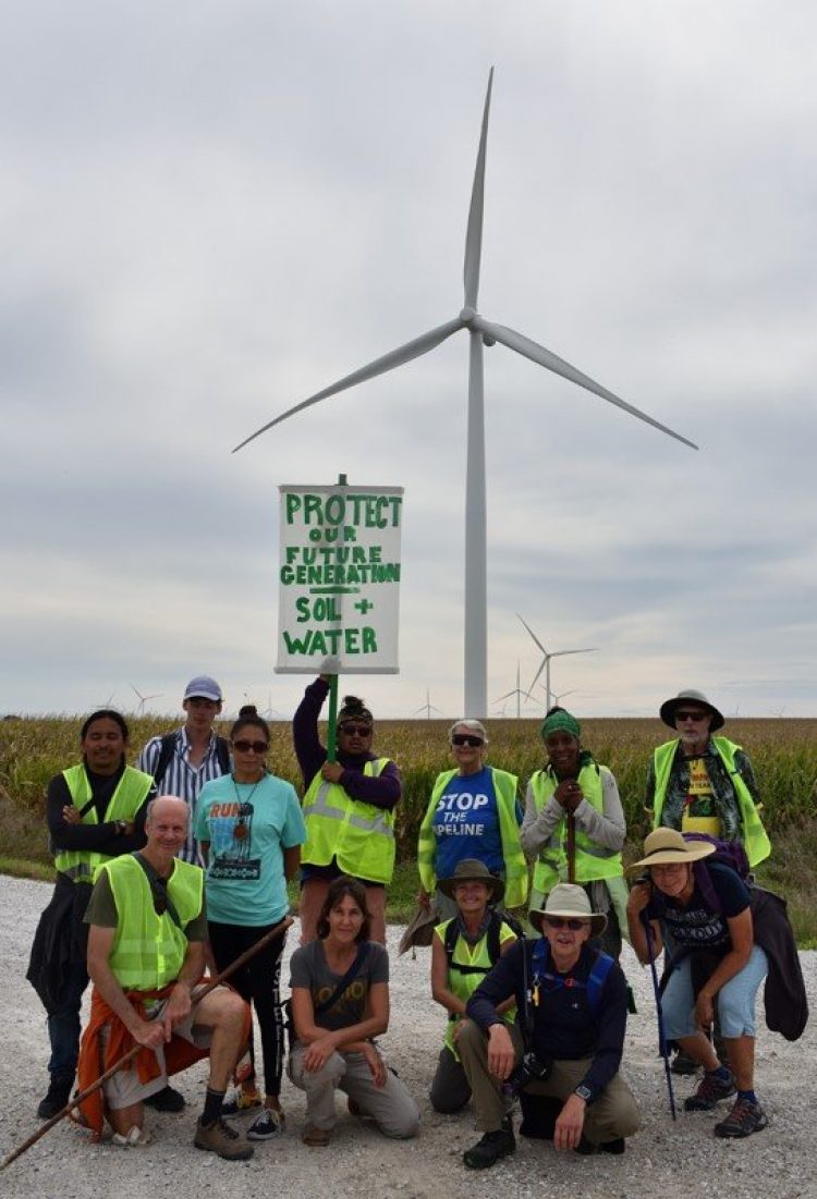 First Nation - Farmer Climate Participants standing in front of wind turbine