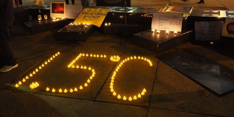 Candles placed on floor to create the numbers 1.5 degrees celsius