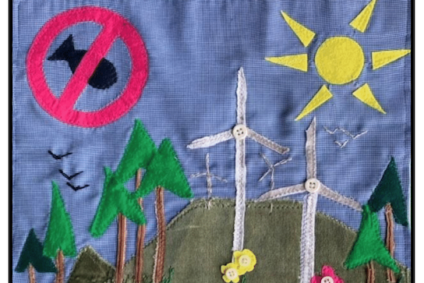 Quilt with wind mills and trees and sun